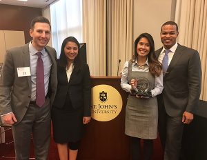 students Chris Piper (far left), Urvashi Morolia (second from left), and Lionel Sims (far right) celebrate their recent national championship at the St. John’s Securities Dispute Resolution Triathlon in New York City with their head coach, STCL Houston alumna Lynn Nguyen (’13).